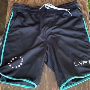 BLACK LVFT WORKOUT SHORTS WITH GREEN ACCENTS